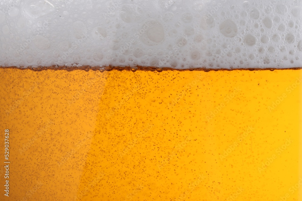Tasty beer with foam as background, closeup Tasty beer with foam as background, closeup