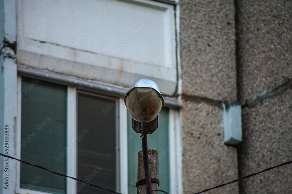 street light lamppost on a blue sky. daytime streetlight. lantern street lighting against day time sky. street lamp on metal pole. lamp street lighting is off.
