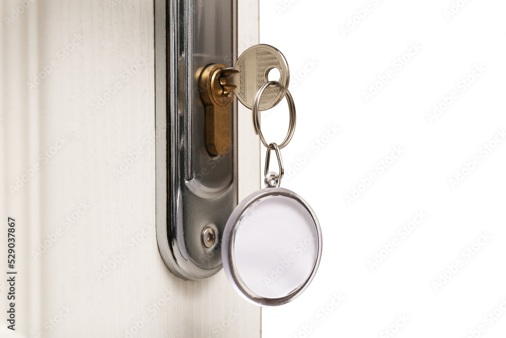 Key with fob in door lock, closeup. Space for text Key with fob in door lock, closeup. Space for text