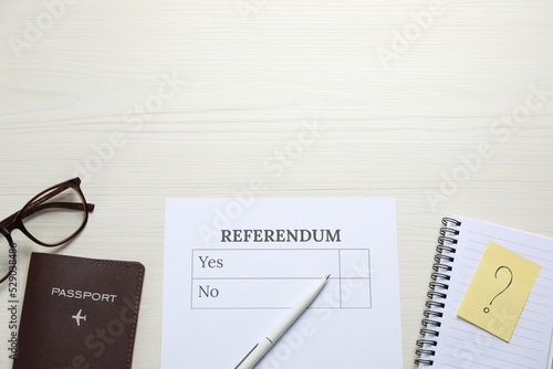 Flat lay composition with referendum ballot on white wooden table. Space for text photo