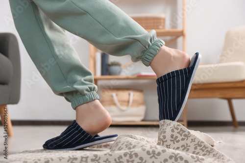 Man tripping over rug at home, closeup