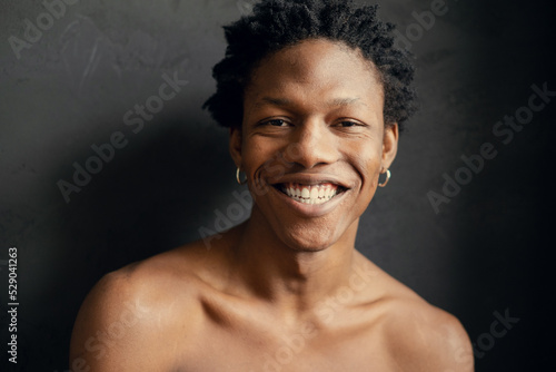 smiling young african man on a black background. copy space © Игорь Гусев