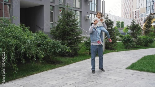 Joyful senior grandfather playing and lifting up happy granddaughter outdoor. Spend leisure time together outdoor for carefree lovely family happiness. High quality 4k footage