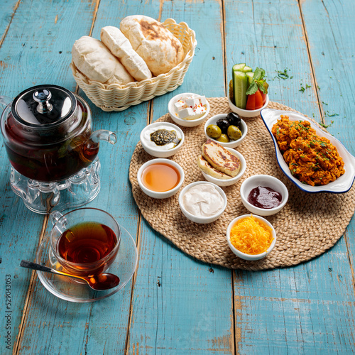 arabic breakfast platter coffee, bread, salad, sauce, dip and pickle isolated on wooden table side view