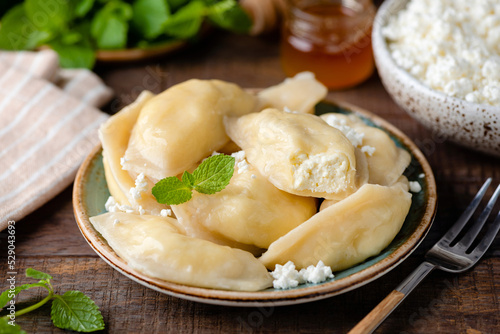 Traiditional Ukrainian Pierogi, Vareniky stuffed with cottage cheese. Sweet dessert or healthy breakfast food, closeup view