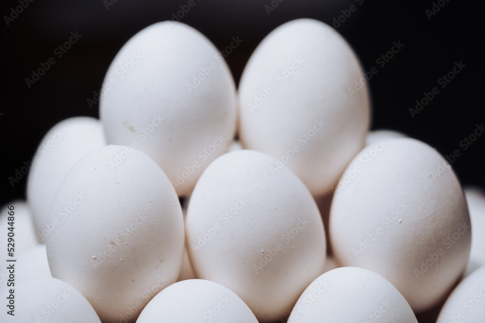 Stack of eggs on paper packing. Chicken white eggs in pyramid. Stack of eggs on paper packing. Chicken white eggs in pyramid.