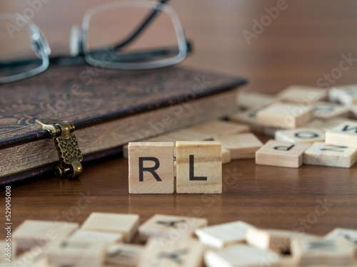 the acronym rl for Reinforcement learning concept represented by wooden letter tiles