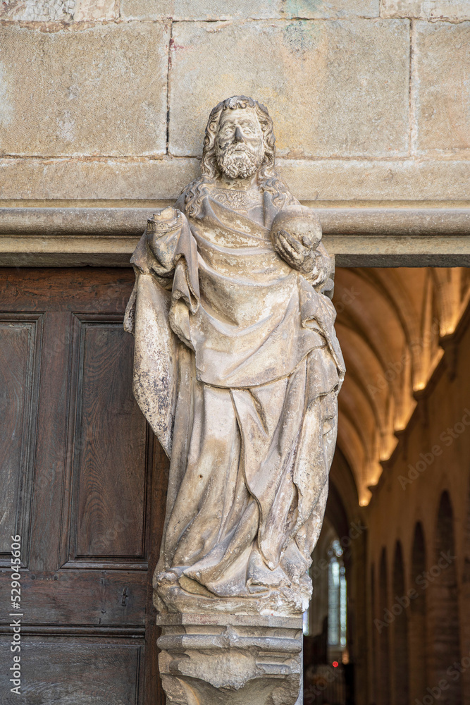 Statue of a saint at the entrance of the Abbey of Baume les Messieurs in the Jura in France