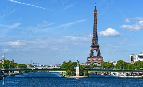 Paris,France.June 2022.Amazing shot that collects two symbols of France: the Eifell tower and the statue of liberty at the base.An iconic image of the city on a beautiful summer day