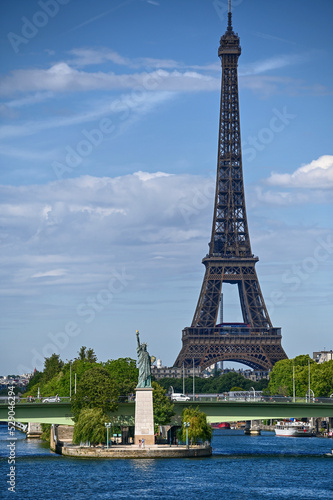 Paris,France.June 2022.Amazing shot that collects two symbols of France: the Eifell tower and the statue of liberty at the base.An iconic image of the city on a beautiful summer day