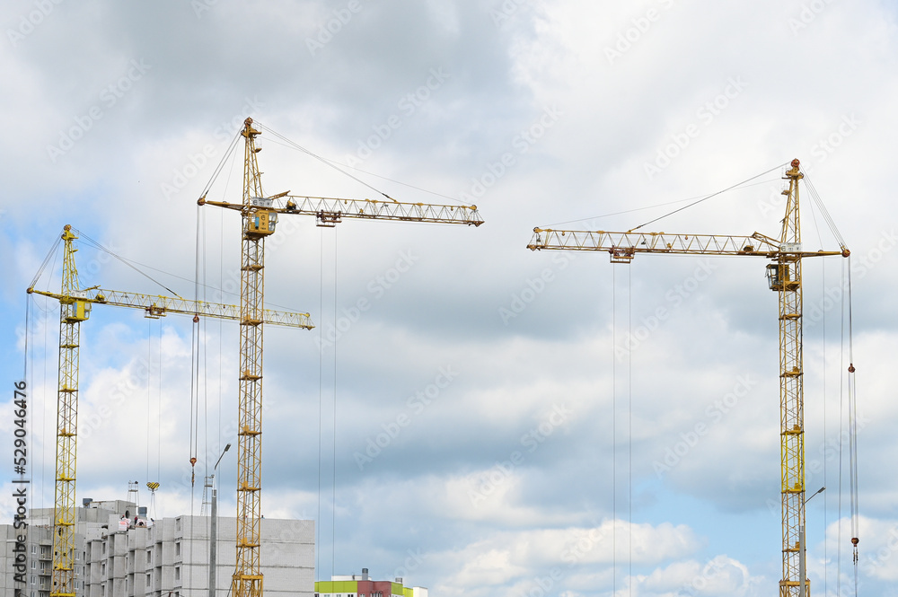 Construction site with cranes, construction of a high-rise building. Construction tower cranes on a building site