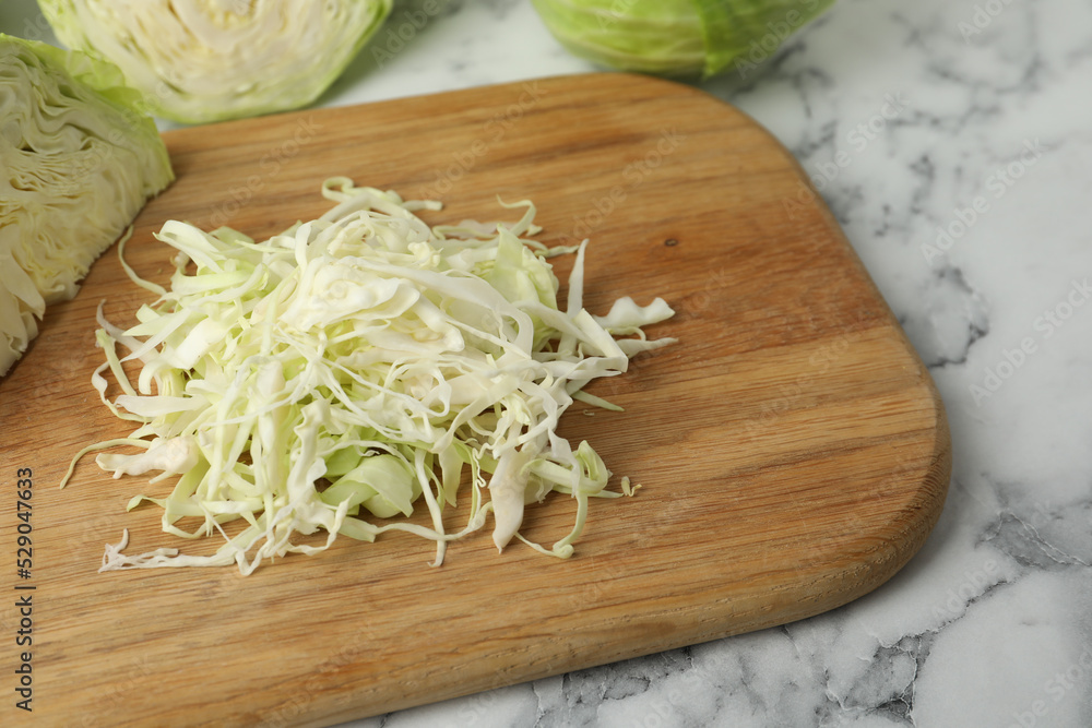 Chopped ripe cabbage on white marble table, closeup Chopped ripe cabbage on white marble table, closeup