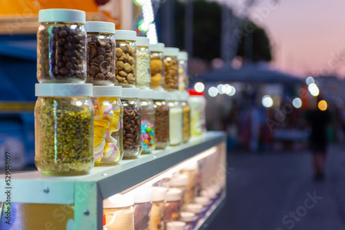 biscuits and candies inside glass mouthpieces in a street stall during a popular festival in Italy