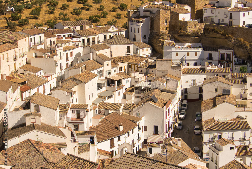 Beautiful panoramic view of Setenil de las Bodegas white houses on a sunny day. Cadiz, spain