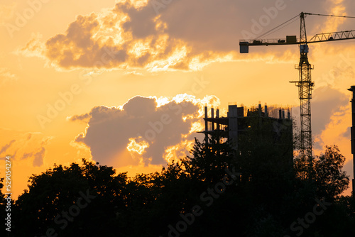 Construction site silhouette at sunset