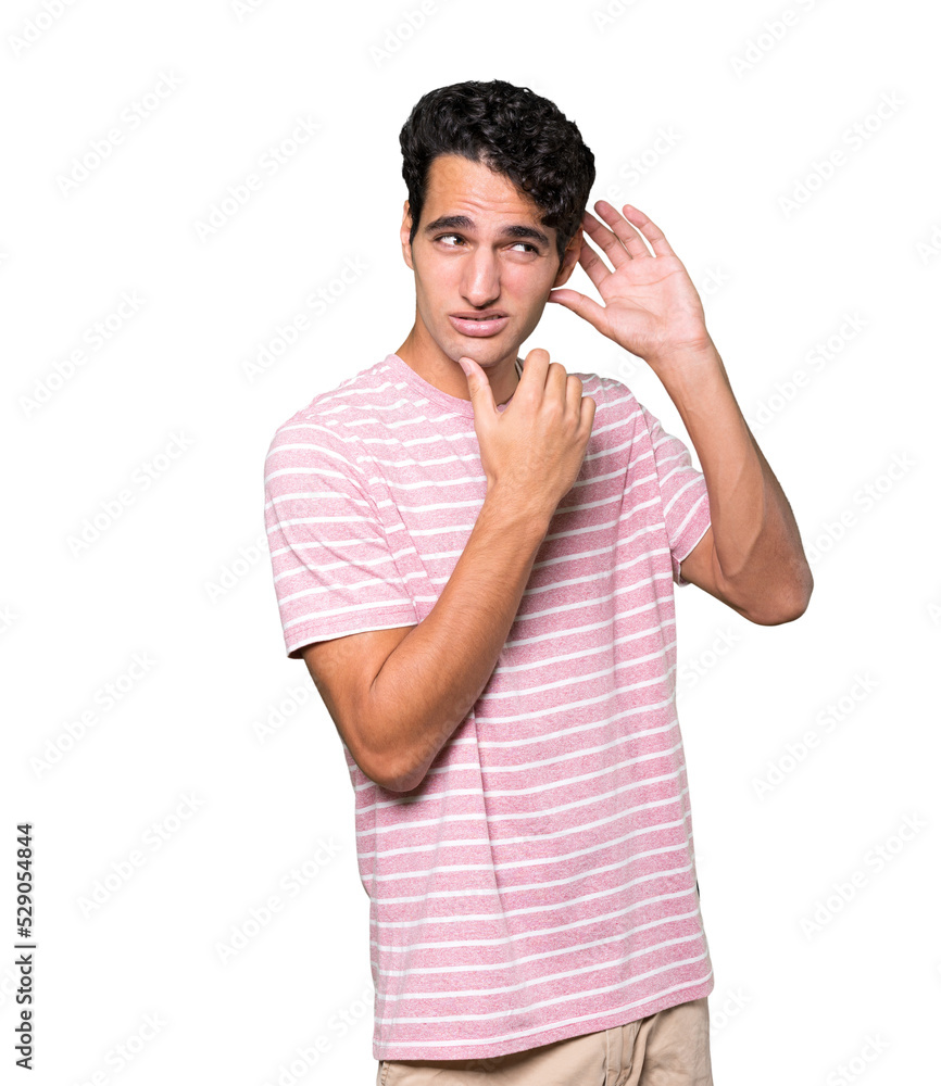 Concentrated young man making a gesture of trying to hear something Concentrated young man making a gesture of trying to hear something