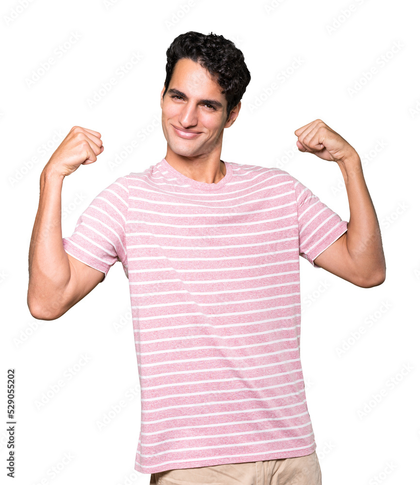 Proud young man doing a gesture of strength with his arm Proud young man doing a gesture of strength with his arm