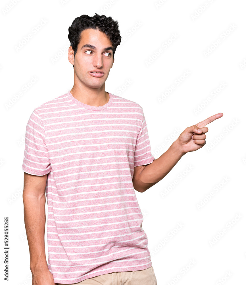 Cool young man pointing with his finger Cool young man pointing with his finger