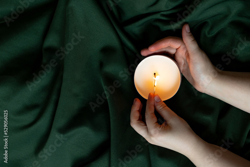 Soy candles in metal cans, handmade modern hobby , harmless coconut wax candles without paraffin on green background  photo