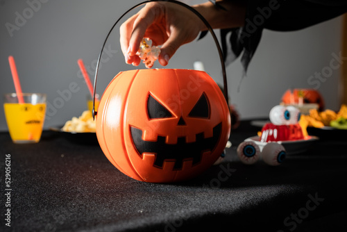 Halloween party decoration. Pumpkin shaped popcorn container photo