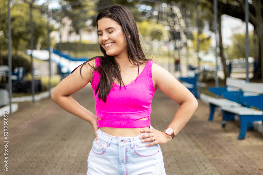 Smiling young girl posing in a park Smiling young girl posing in a park