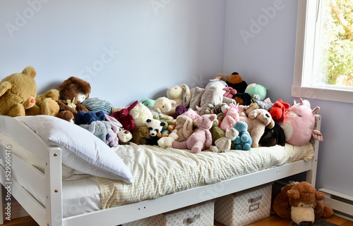Cute and fun but crowded child's bedroom with too many plush stuffies
