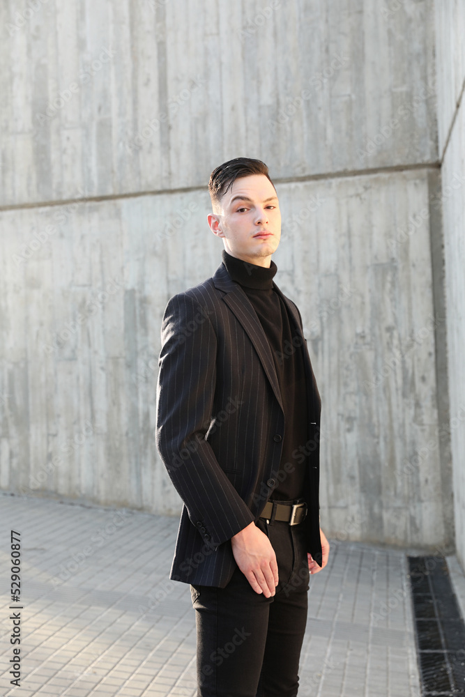 Handsome smiling stylish hipster young man. Fashion male posing outdoor. Handsome smiling stylish hipster young man. Fashion male posing outdoor.