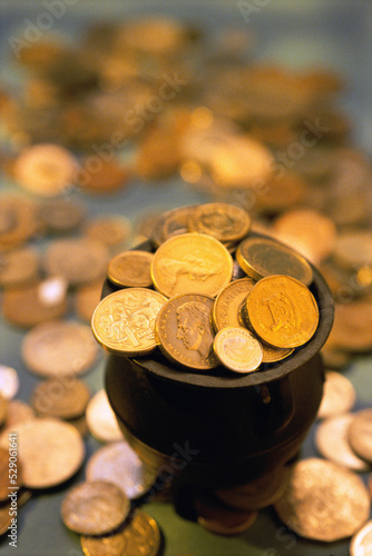 Close-up of gold coins in a pot