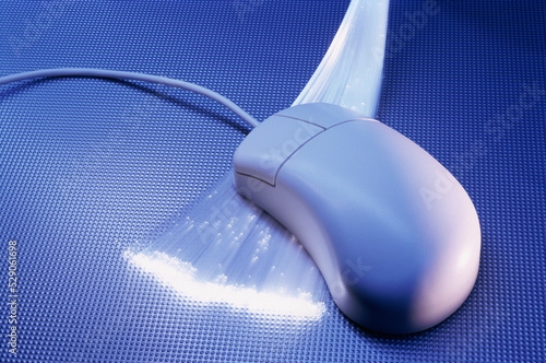 Close-up of a computer mouse over optic fibers