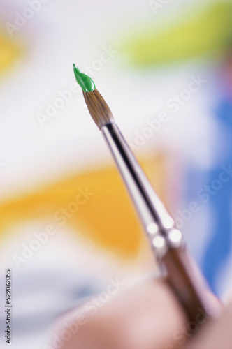 Close-up of a person holding a paintbrush