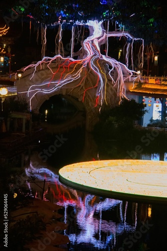 Vertical shot of the illuminated details of the Impression Water street in Meishan city, Chna photo