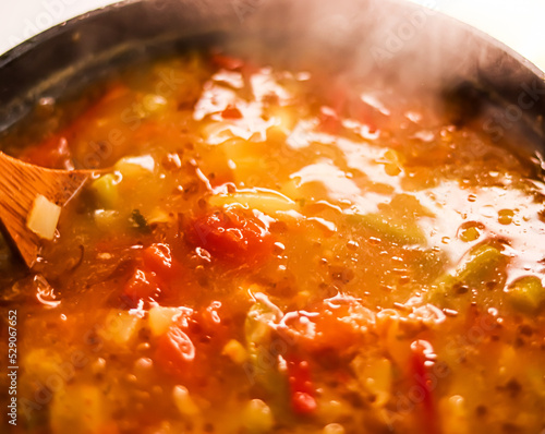 Cooking vegetable soup in saucepan, comfort food and homemade meal concept photo