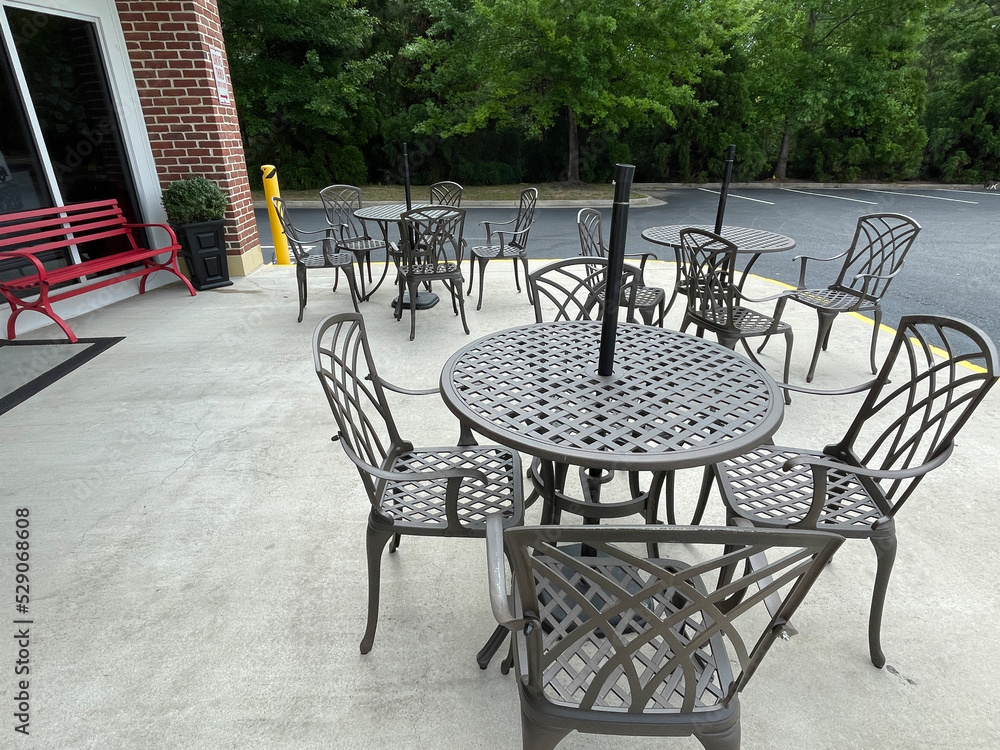 Outdoors dining cast iron dinner tables retail strip mall store sidewalk