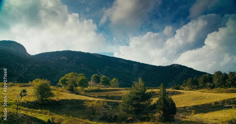 Epic cinematic timelapse on mountain meadow landscape at summer vacation travel. Beautiful clouds moving fast on the sky. Relaxation and calm scenery of cloudscape Epic cinematic timelapse on mountain meadow landscape at summer vacation travel. Beautiful clouds moving fast on the sky. Relaxation and calm scenery of cloudscape
