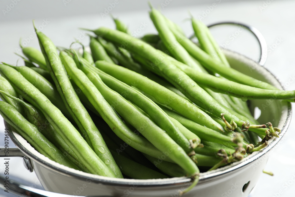 Fresh green beans in colander, closeup view Fresh green beans in colander, closeup view