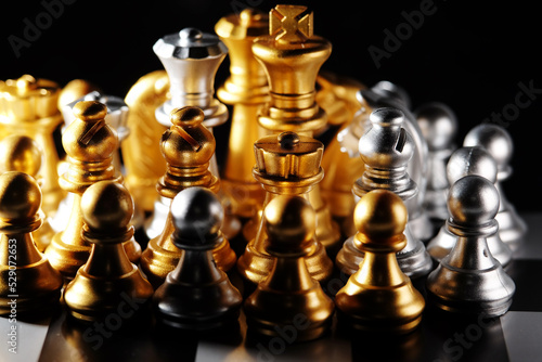 Close up of golden and silver chess piece