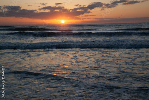 Sunrise over the ocean waves
