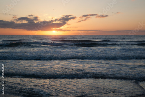 Sunset over the ocean waves
