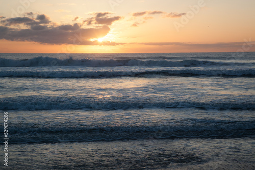 Sunrise over the ocean waves