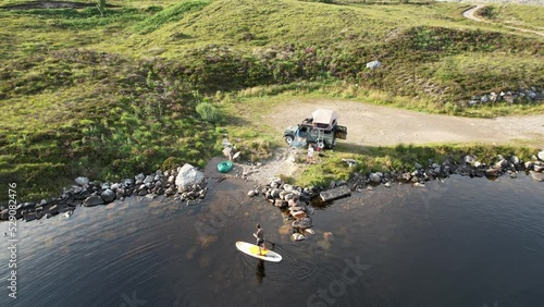 Awerial view of people relaxing with a canoe along Loch Tollaidh, Scotland. photo