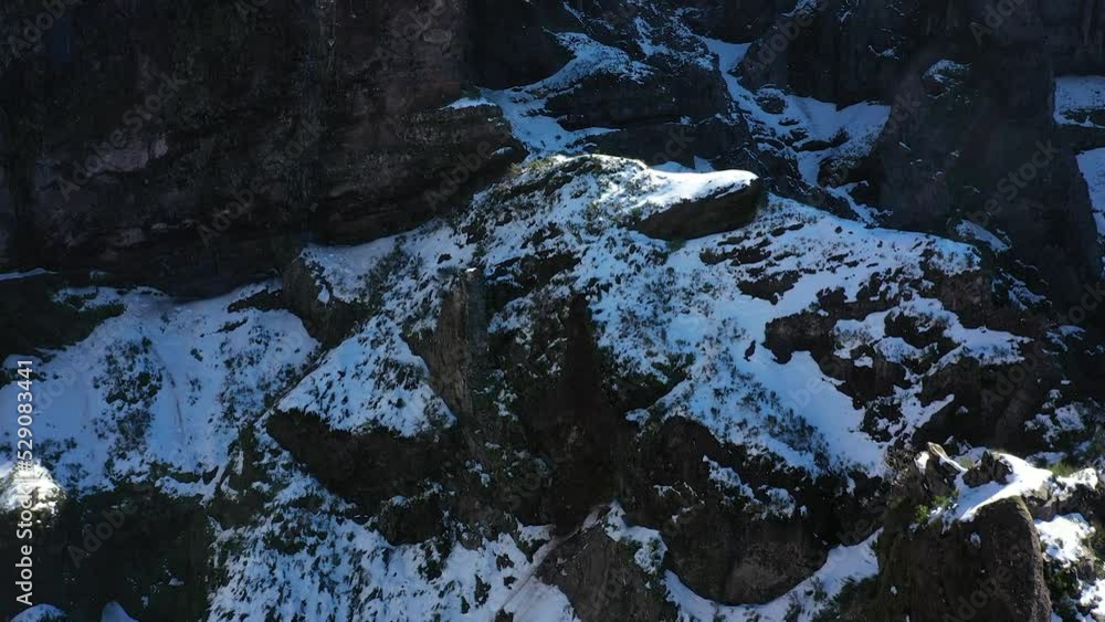 Drone shot of Pico Ruivo snow covered cliffs at the top. Drone shot of Pico Ruivo snow covered cliffs at the top.
