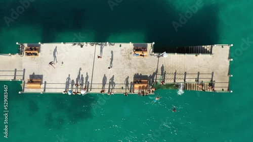 Still drone shot of a pier with people in Porto Santo, Madeira. photo
