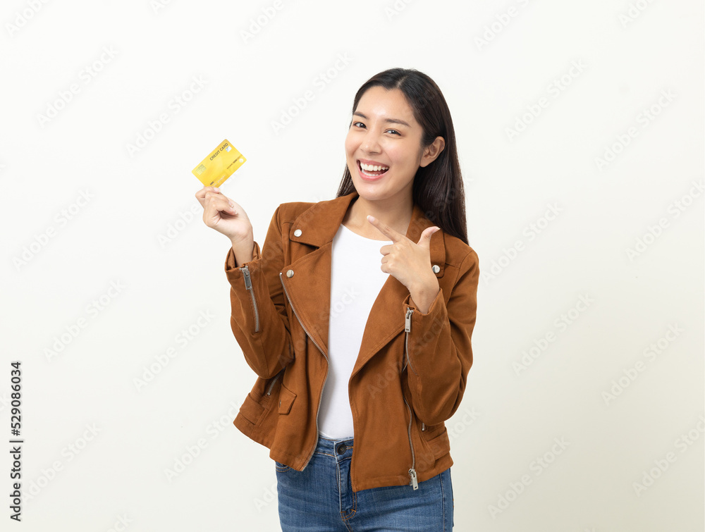 Portrait beautiful asian women in jacket fashion jean standing pose holding credit card to shopping payment. Attractive Happy businesswoman with creditcard. Portrait beautiful asian women in jacket fashion jean standing pose holding credit card to shopping payment. Attractive Happy businesswoman with creditcard.