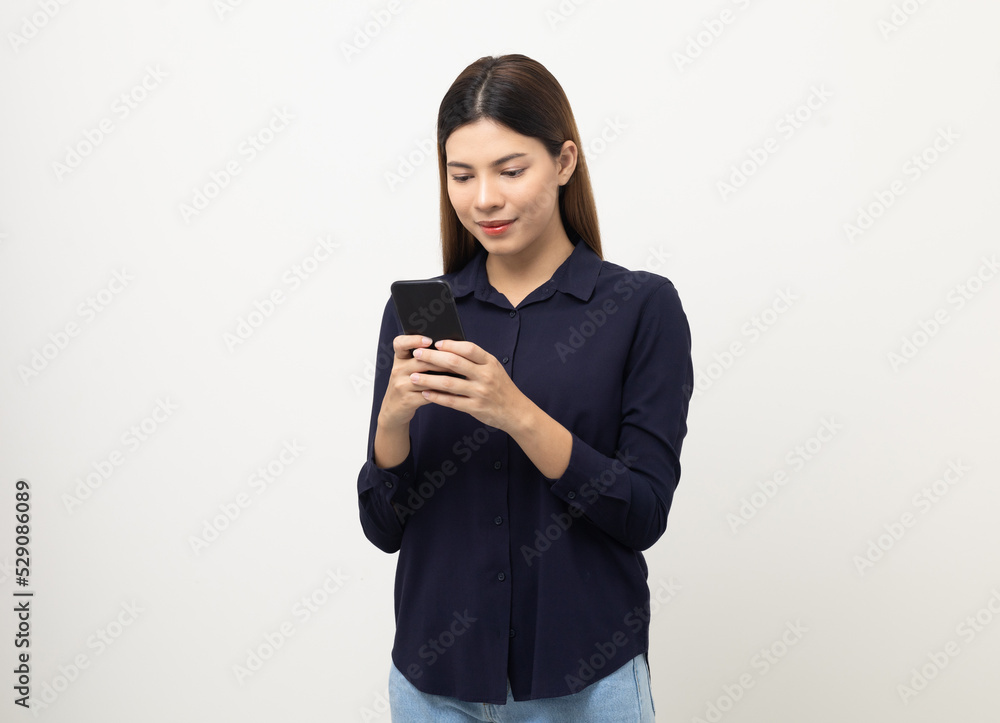 Pretty young mixed race woman using smartphone standing on isolated white background. She texting on cell phone. Feeling happy and excited Pretty young mixed race woman using smartphone standing on isolated white background. She texting on cell phone. Feeling happy and excited