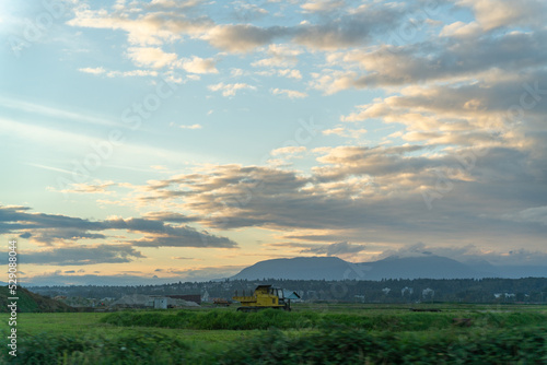 farm land in the city. sunset, moiuntain, clouds