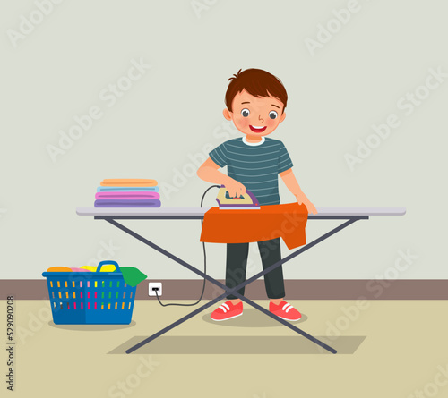 cute little boy ironing clothes doing daily chores housework activity 