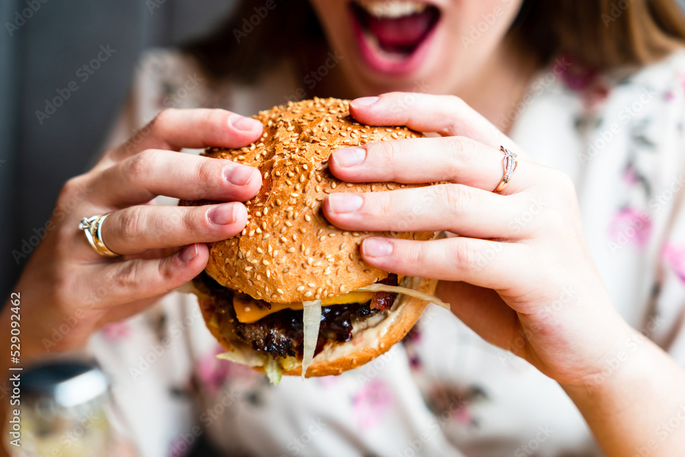 Hamburger eating pregnancy woman. Hungry pregnant girl bting burger. Fast food, people and