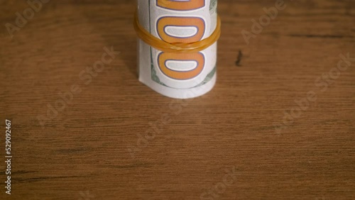 Dollar banknotes left on table. A view of roled money on the table indoor. A concept of financial savings during crisis. photo