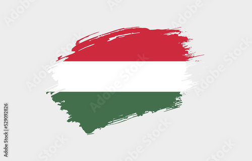 Creative hand drawn grunge brushed flag of Hungary with solid background