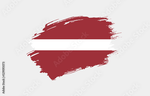 Creative hand drawn grunge brushed flag of Latvia with solid background